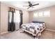 Cozy bedroom with plush carpeting, ceiling fan, and a window offering plenty of natural light at 3022 Cameron St, Indianapolis, IN 46203