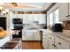 White kitchen cabinets, black appliances, and brick accent wall at 3022 Cameron St, Indianapolis, IN 46203