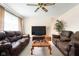 Comfortable living room with two plush leather sofas, a ceiling fan, and a warm, inviting ambiance at 3022 Cameron St, Indianapolis, IN 46203