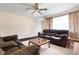 Relaxing living room with leather seating, neutral carpet, a ceiling fan, and ample natural light at 3022 Cameron St, Indianapolis, IN 46203