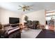 Spacious living room with two leather sofas, a ceiling fan, and a view of an adjacent room at 3022 Cameron St, Indianapolis, IN 46203