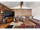 Inviting living room features log walls, vaulted ceiling and a comfortable sectional sofa at 3022 Cameron St, Indianapolis, IN 46203