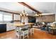 Open-concept space featuring a wooden island with seating, plus a spacious living area with rustic decor at 3022 Cameron St, Indianapolis, IN 46203
