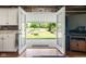 View from kitchen to back yard through glass patio doors and covered patio at 3022 Cameron St, Indianapolis, IN 46203