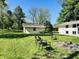 Spacious backyard featuring a fire pit, chairs, and a shed, ideal for outdoor gatherings at 3081 Woodridge Rd, Shelbyville, IN 46176