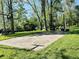Outdoor basketball court surrounded by lush greenery, offering a space for recreation and exercise at 3081 Woodridge Rd, Shelbyville, IN 46176