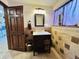 Bathroom with a vanity, decorative wall tiles, and an open door at 3081 Woodridge Rd, Shelbyville, IN 46176