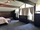 This bedroom features large windows, wood paneling, ceiling beams, and ample closet space at 3081 Woodridge Rd, Shelbyville, IN 46176