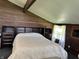 Comfortable bedroom with built-in storage around the bed, wood paneling, and a sunny window at 3081 Woodridge Rd, Shelbyville, IN 46176