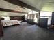 This spacious bedroom boasts vaulted ceilings, ceiling beams, large windows, and wood paneling at 3081 Woodridge Rd, Shelbyville, IN 46176