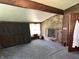 Spacious bedroom featuring a charming brick fireplace, wood paneling, and large windows at 3081 Woodridge Rd, Shelbyville, IN 46176