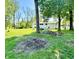 Exterior of the white house, featuring a well-manicured lawn and lovely surrounding greenery at 3081 Woodridge Rd, Shelbyville, IN 46176