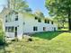 Bright white two-story house exterior featuring large windows and a well-maintained lawn on a sunny day at 3081 Woodridge Rd, Shelbyville, IN 46176