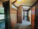 Hallway with wood paneling on the walls and doorways at 3081 Woodridge Rd, Shelbyville, IN 46176