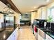 Modern kitchen featuring stainless steel appliances, granite countertops, island, and cozy adjoining Gathering room at 3081 Woodridge Rd, Shelbyville, IN 46176