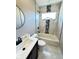 Modern bathroom showcasing a tiled bathtub, vanity with dark cabinetry and modern fixtures at 337 N Beville Ave, Indianapolis, IN 46201