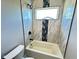 Bright bathroom features a tub with tiled walls and a window at 337 N Beville Ave, Indianapolis, IN 46201