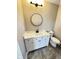 Well-lit bathroom showcasing a white vanity, modern black fixtures, and grey tile flooring at 337 N Beville Ave, Indianapolis, IN 46201