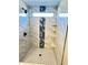 Modern shower featuring stylish tilework, sleek fixtures, and convenient built-in shelves at 337 N Beville Ave, Indianapolis, IN 46201