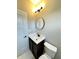 Modern bathroom featuring dark vanity, round mirror, and neutral walls at 337 N Beville Ave, Indianapolis, IN 46201