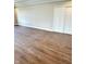 Spacious bedroom featuring wood flooring, neutral walls, closet with sliding doors, and natural light at 337 N Beville Ave, Indianapolis, IN 46201