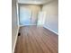 Spacious bedroom featuring wood laminate flooring, white trim, and a neutral color palette at 337 N Beville Ave, Indianapolis, IN 46201