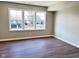 A well-lit bedroom features a neutral color scheme, three windows, and laminate wood flooring at 337 N Beville Ave, Indianapolis, IN 46201