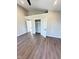 Bedroom showcasing wood laminate flooring, closet, and a stylish, modern look at 337 N Beville Ave, Indianapolis, IN 46201