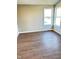 Bright bedroom features wood laminate flooring, neutral walls, and natural lighting at 337 N Beville Ave, Indianapolis, IN 46201
