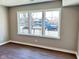 A well-lit bedroom features a neutral color scheme, three windows, and laminate wood flooring at 337 N Beville Ave, Indianapolis, IN 46201