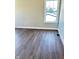 Bedroom featuring wood laminate flooring, white trim, and natural light at 337 N Beville Ave, Indianapolis, IN 46201