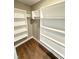 Walk-in closet with ample shelving and neutral walls at 337 N Beville Ave, Indianapolis, IN 46201