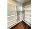 Walk-in closet with ample shelving and neutral walls at 337 N Beville Ave, Indianapolis, IN 46201
