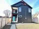 Striking modern home with a two-story design, balcony, and vibrant blue door at 337 N Beville Ave, Indianapolis, IN 46201
