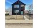 Charming two-story house featuring a modern design with black exterior and fenced yard at 337 N Beville Ave, Indianapolis, IN 46201