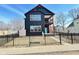 Modern two-story home with black siding, white trim, and a welcoming blue front door at 337 N Beville Ave, Indianapolis, IN 46201