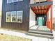 Modern front porch with a striking blue door, steps, and contemporary design at 337 N Beville Ave, Indianapolis, IN 46201