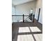 A well-lit upstairs hallway overlooks the staircase and features laminate wood flooring and white painted walls at 337 N Beville Ave, Indianapolis, IN 46201