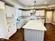 Modern kitchen with white cabinets, quartz countertops, and a center island at 337 N Beville Ave, Indianapolis, IN 46201
