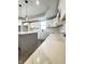 Bright kitchen features an island, modern lighting, white cabinets, quartz countertops and stainless steel sink at 337 N Beville Ave, Indianapolis, IN 46201