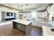 Bright kitchen features an island, modern lighting, white cabinets, quartz countertops and stainless steel sink at 337 N Beville Ave, Indianapolis, IN 46201