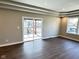 Spacious living room with stylish trey ceiling, access to deck via sliding glass door, and wood flooring at 337 N Beville Ave, Indianapolis, IN 46201