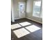 Bright living room with modern wood flooring and natural light from a large window and glass door at 337 N Beville Ave, Indianapolis, IN 46201