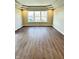 Open and airy living room featuring hardwood floors, neutral walls, and large picture window at 337 N Beville Ave, Indianapolis, IN 46201
