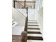 Beautiful staircase with white risers, wood treads, a wood handrail, and decorative black iron spindles at 337 N Beville Ave, Indianapolis, IN 46201