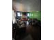 Cozy living room with a brick fireplace, large window, and plenty of natural light at 3731 N Tacoma Ave, Indianapolis, IN 46218