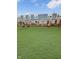 Backyard with vibrant green lawn and black iron fence line create a comfortable outdoor space at 3811 N Lawndale Ave, Indianapolis, IN 46254