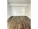 Unfinished basement space with wood-look flooring and white walls provides a modern foundation at 3811 N Lawndale Ave, Indianapolis, IN 46254