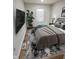 Comfortable bedroom features wood-look floors, neutral colors, and a mounted TV at 3811 N Lawndale Ave, Indianapolis, IN 46254
