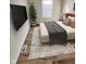Cozy bedroom features wood-look floors, mounted TV, and a window for natural light at 3811 N Lawndale Ave, Indianapolis, IN 46254